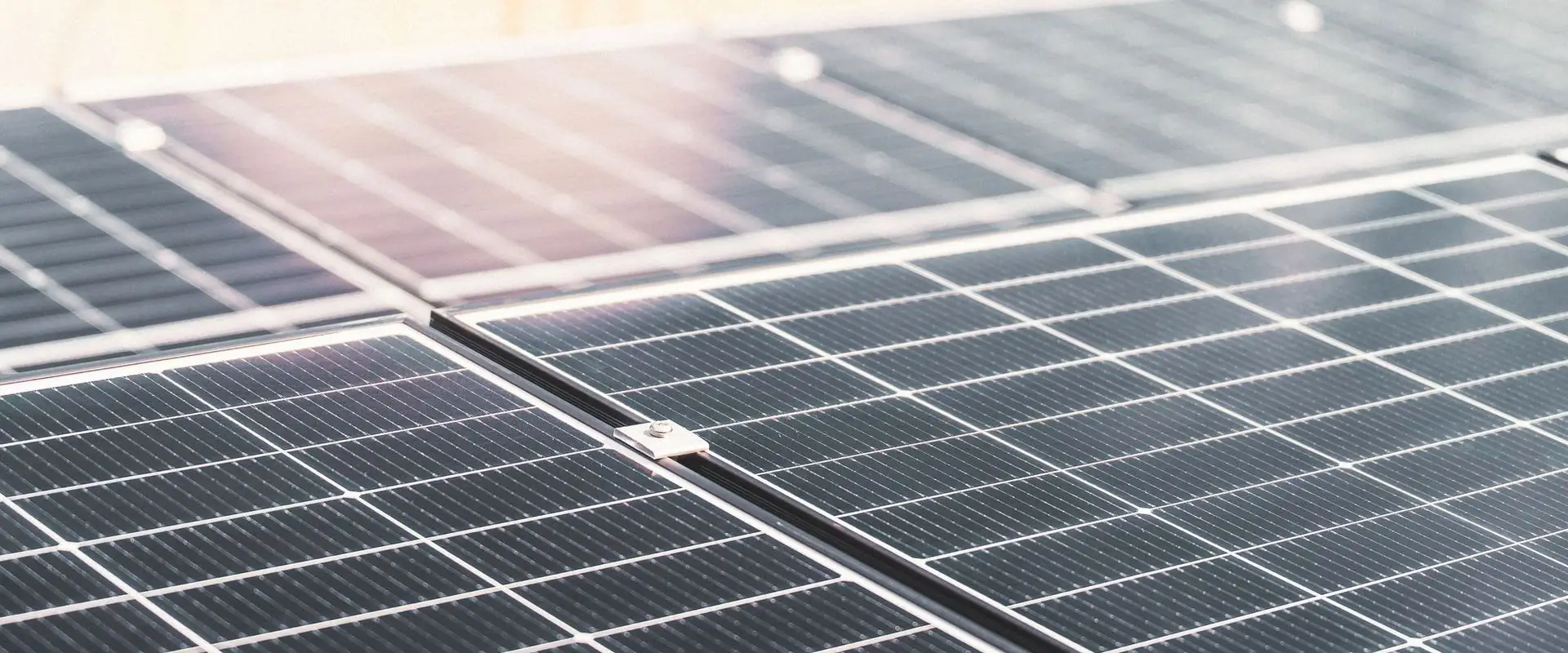 Rooftop solar panels in direct sunlight, close and filling the frame.