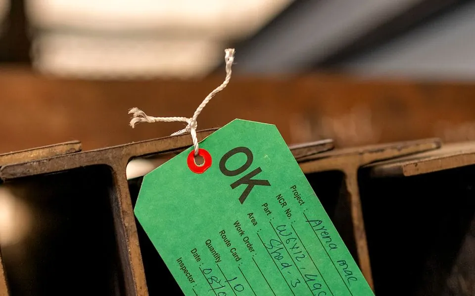 An inspection tag marked OK against steel.
