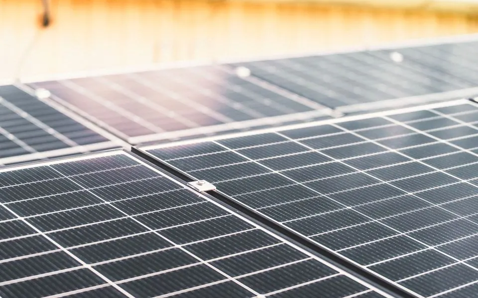 The cells of a rooftop solar panel in direct sun.