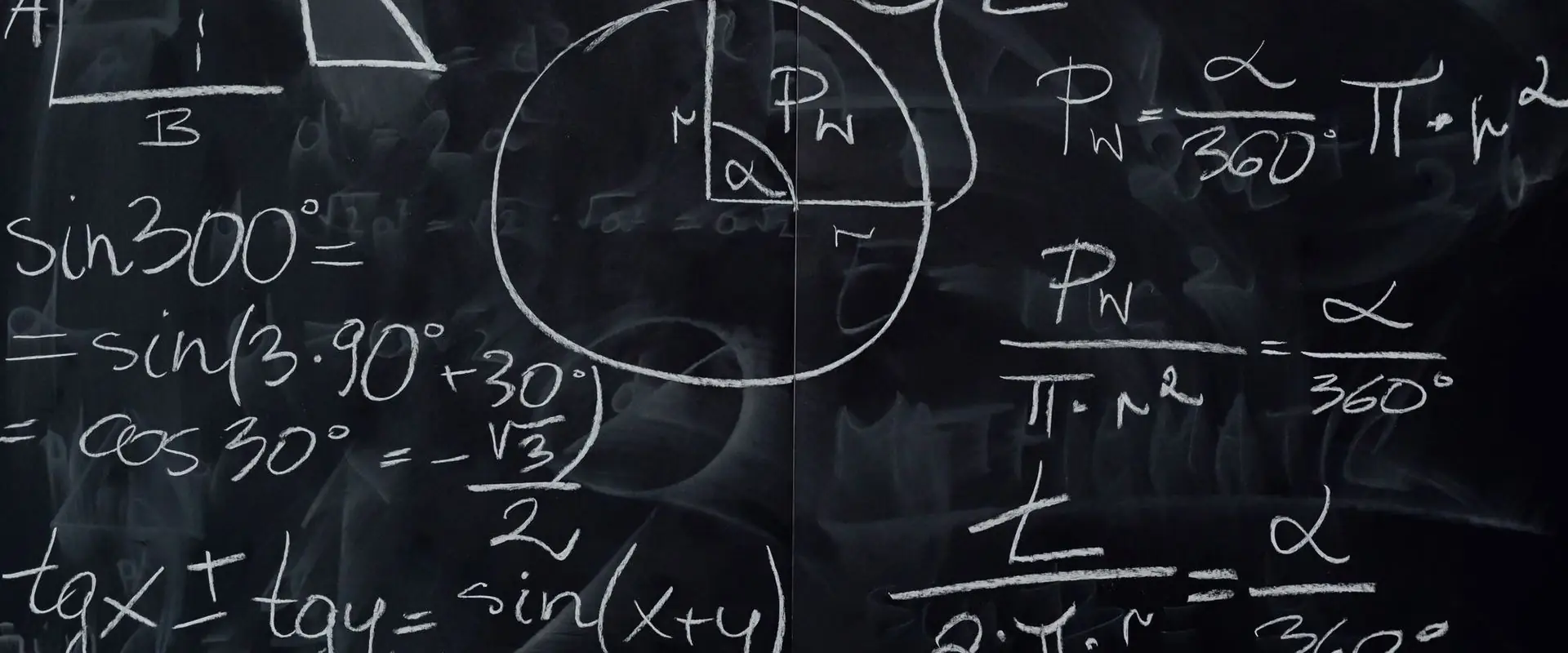 Mathematical working covering a blackboard in chalk.