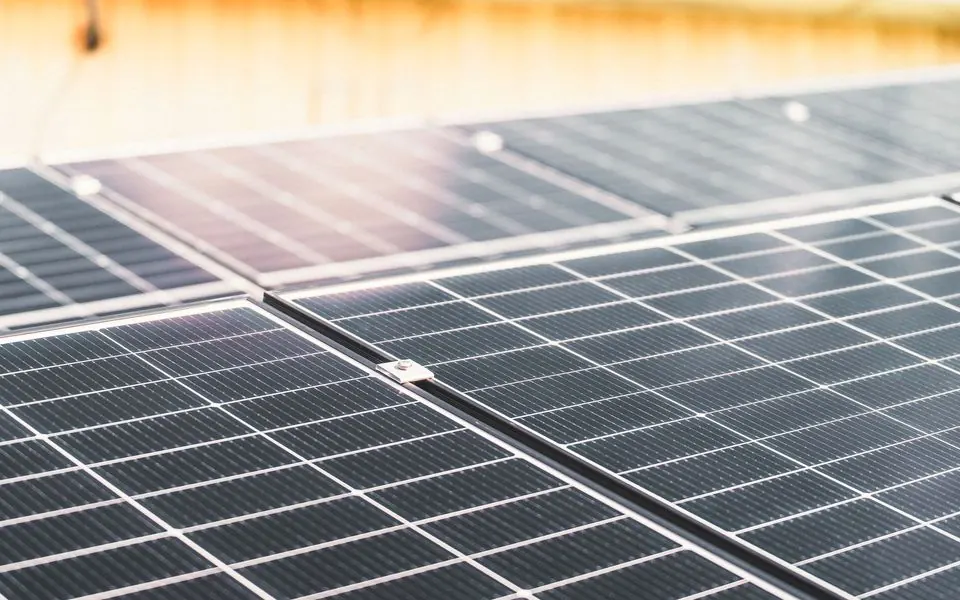 The cells of a rooftop solar panel, close.