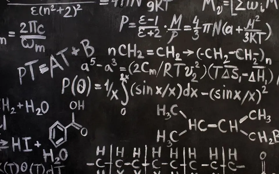 A corner of a blackboard covered in chemical notation.